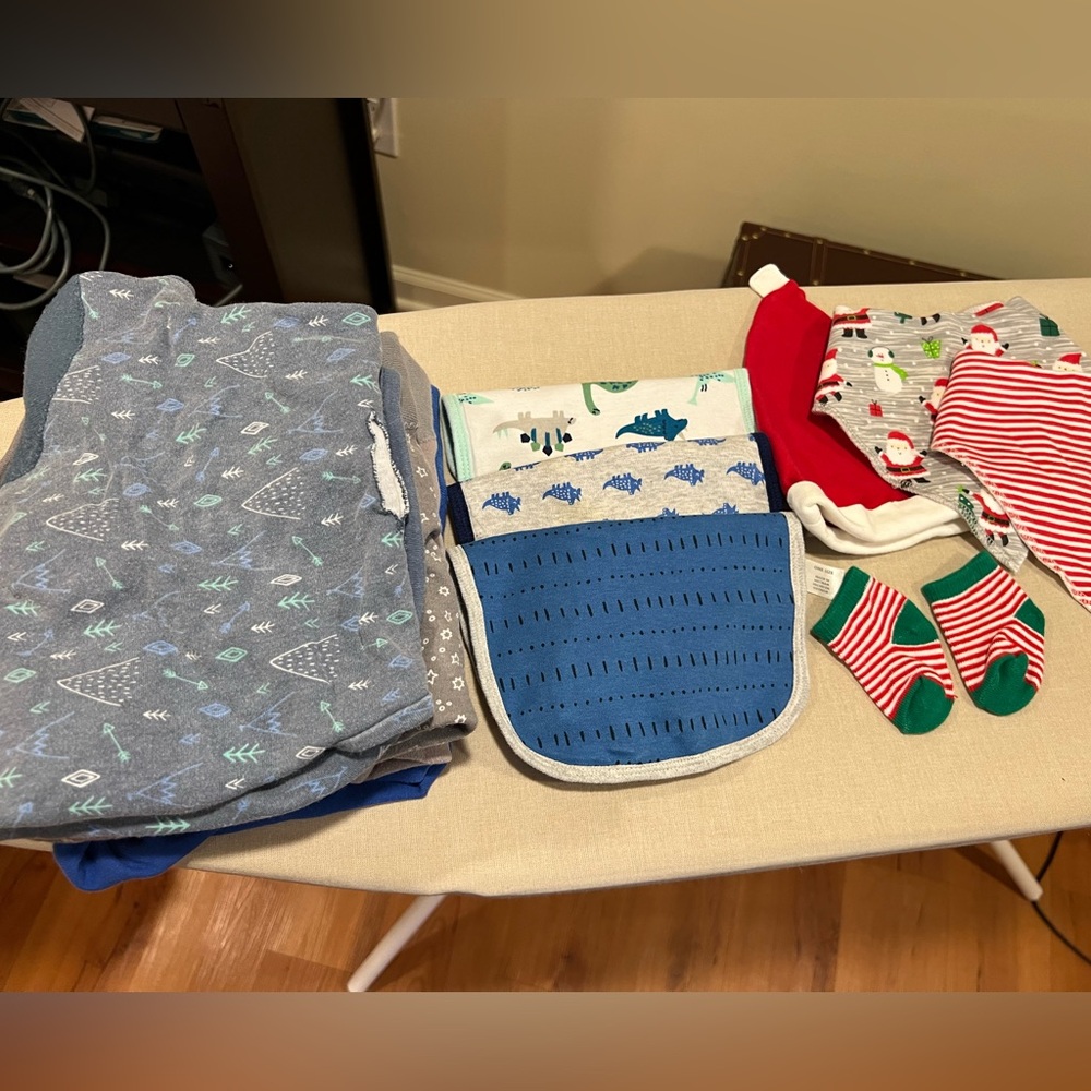 Assortment of new born essentials, 5 bibs, 5 swaddles, 1 hat and 1 pair socks.